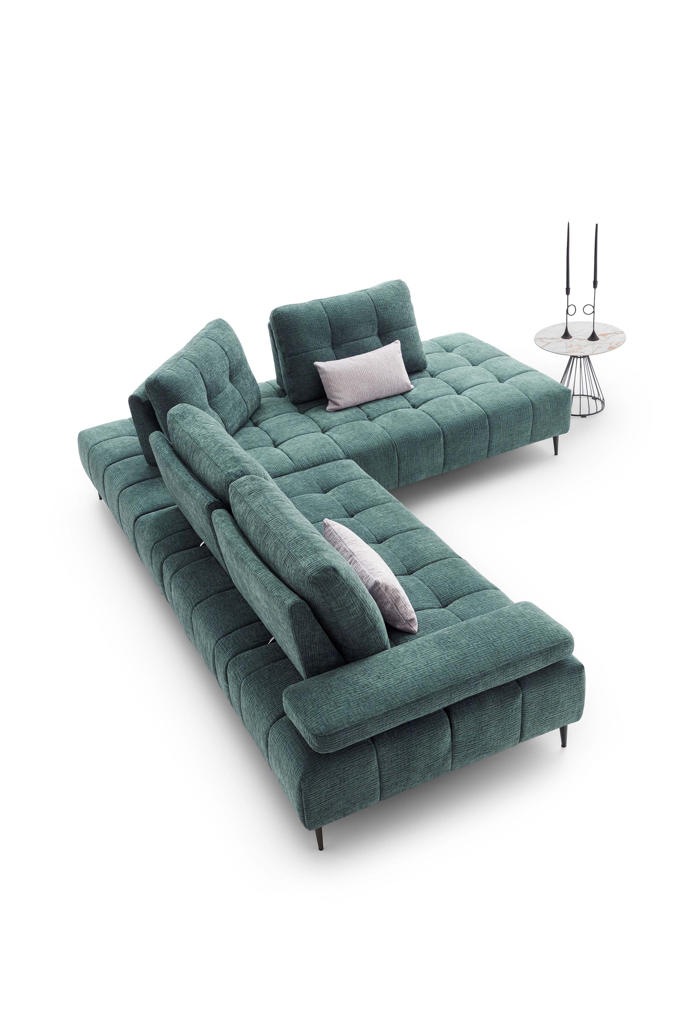 Divano in tessuto verde con cuscini color argento. Schienali traslabili che modificano la profondità di seduta.
