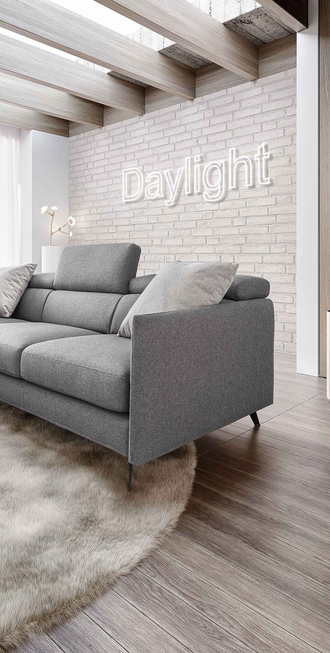 Divano moderno grigio inserito in un soggiorno dai toni bianco-grigi