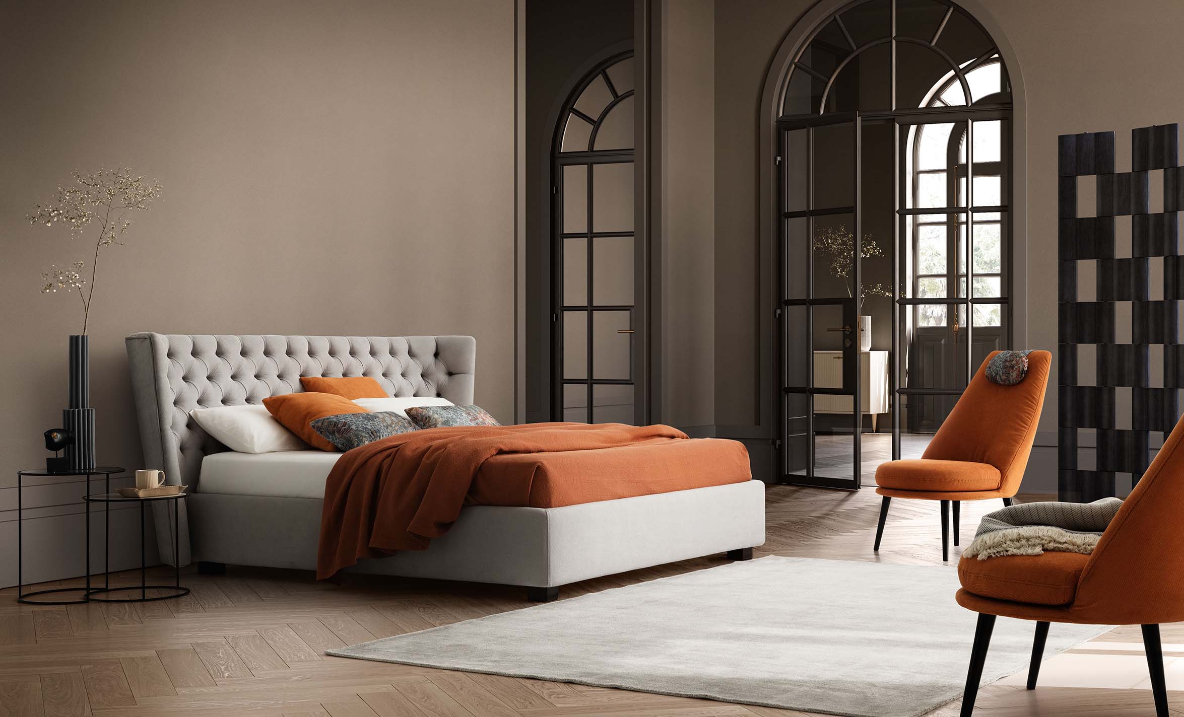 Stanza classica arredata con letto in stile chesterfield con piedini bassi e giroletto ampio