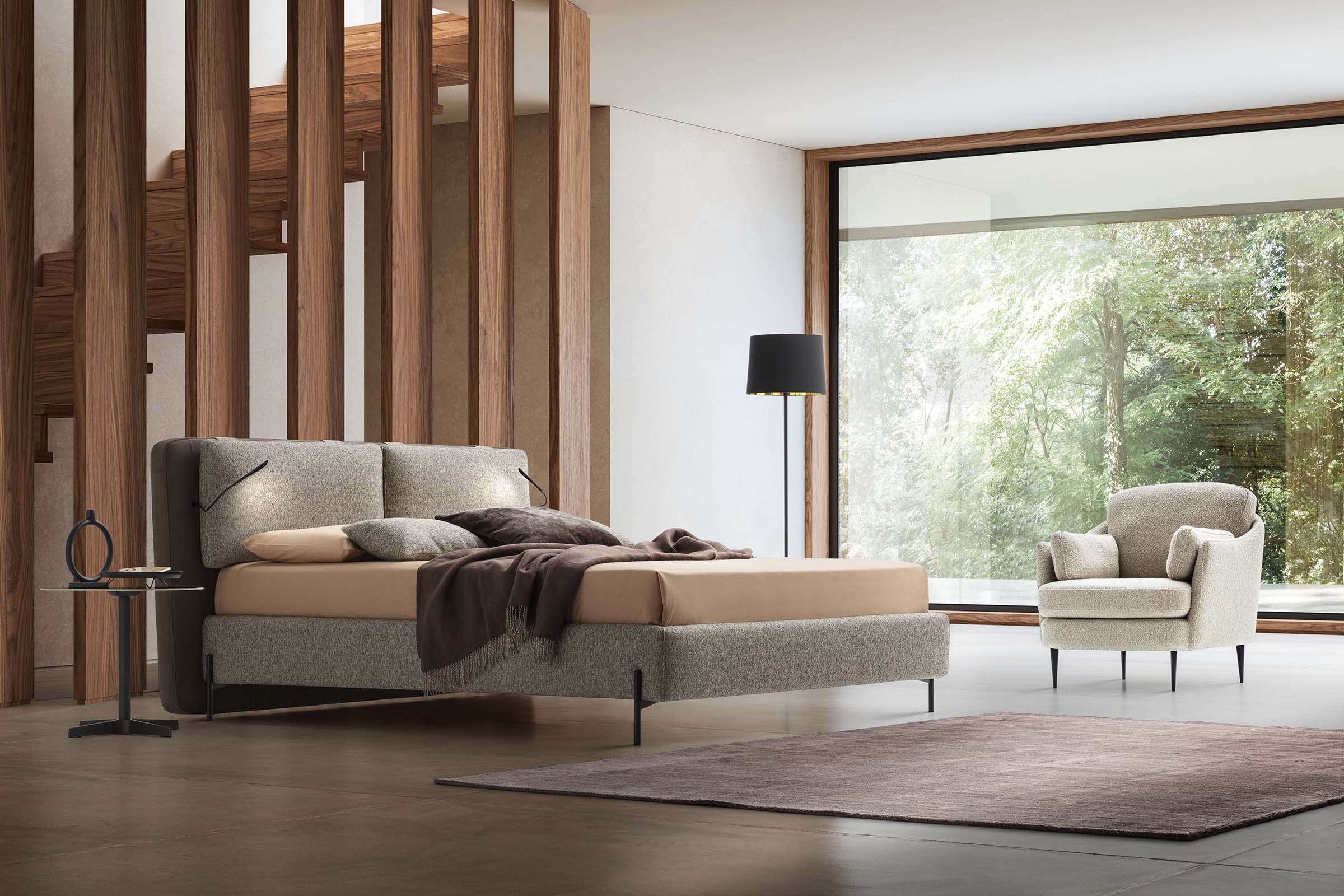 Camera da letto moderna con letto moderno con luci LED integrate e piedini sottili e di design