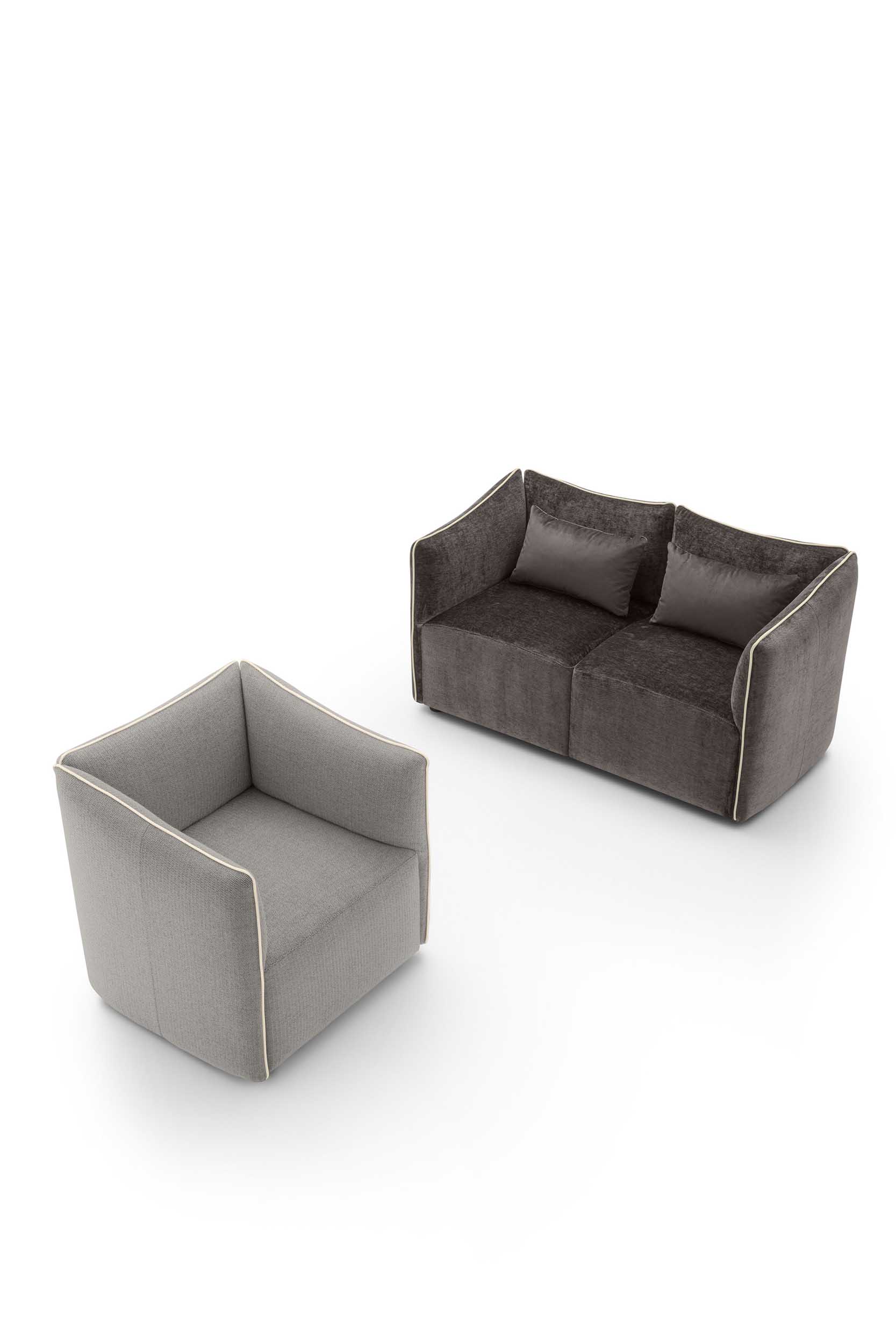 Poltroncina grigia cubica con bordature in rilievo a contrasto